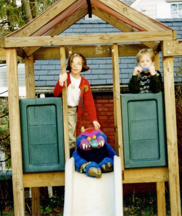 Clare, Andrew and a visiting monster on swing set 1996