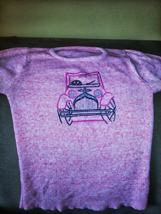 pink t-shirt with Rolls Royce or Bently embroidered on front in sparkly thread