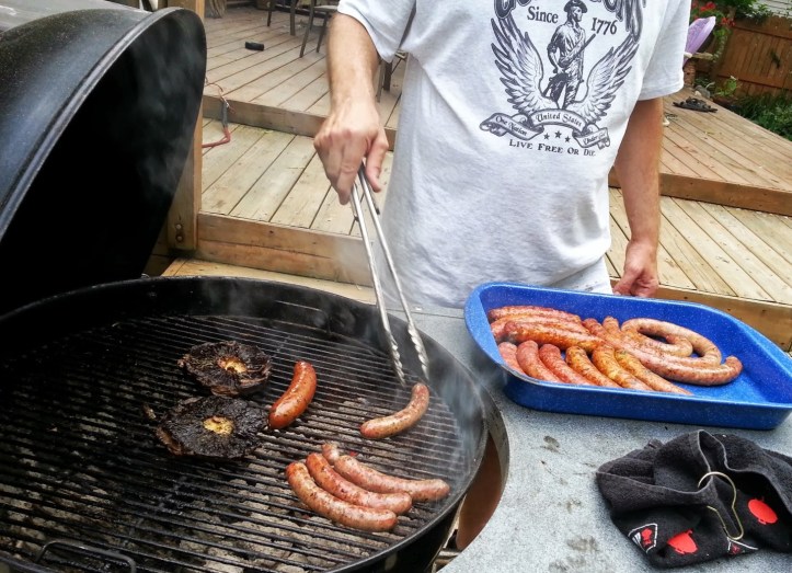 Kevin cooking sausages and mushrooms