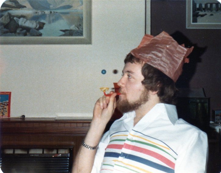 Jeremy with a christmas cracker toy and silly hat