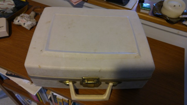 Closed off-white hair dryer case.