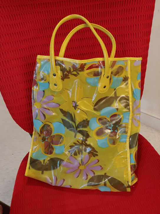 Clear plastic carrying bag with purple flowers